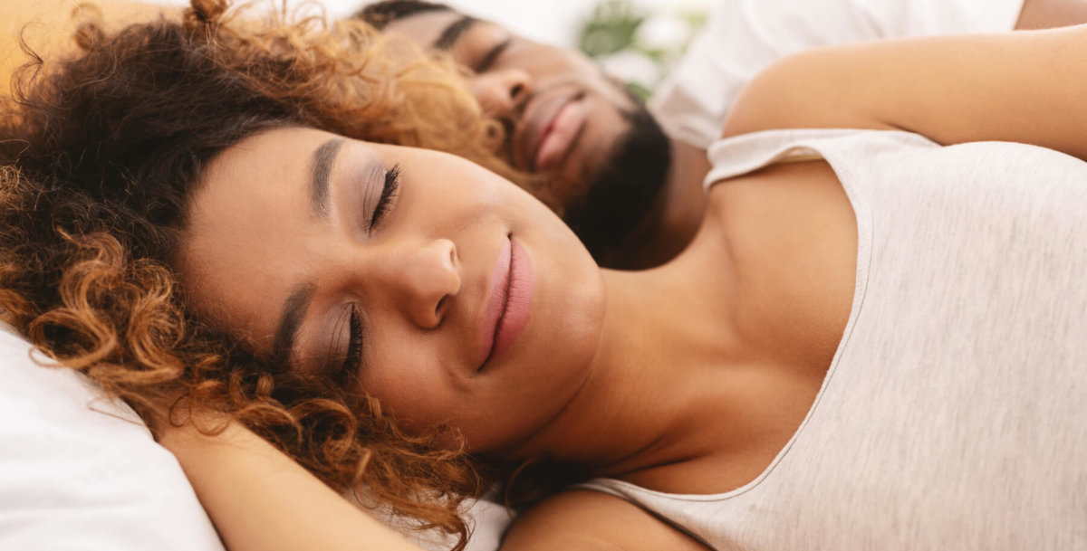 Man and woman in bed sleeping peacefully