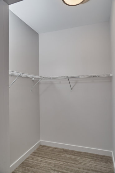 Spacious walk-in closet off the master bedroom in our 2-bedroom townhome.
