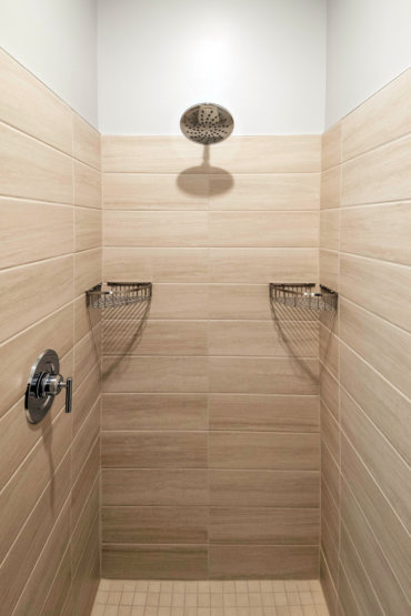 Master en suite bathroom in our 2-bedroom townhome, complete with tile shower and glass door.