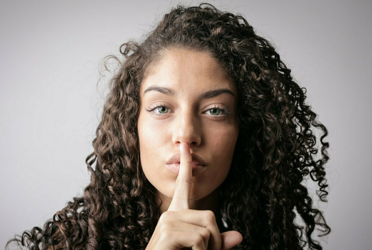 Woman making "shush" gesture with her finger