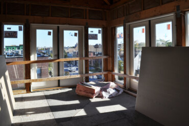 Insulation and drywall are about to be put up in a two-bedroom corner apartment (2-D) on the top floor of Building D.
