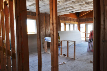 Insulation being installed in a two-bedroom apartment (2-A) in building D.