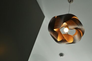 Photo of a ceiling-mounted light fixture in a public hallway.