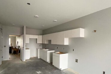 The kitchen cabinets have been installed in this 1-bedroom, 1-bathroom apartment (Unit 1C) in Building B.