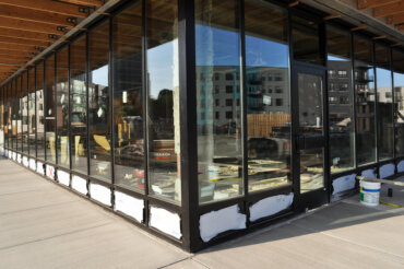 Windows are installed in the first floor retail space of Building B.
