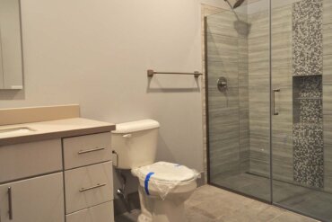 The bathroom of this 2-bedroom apartment (Unit 2C) features a beautiful walk-in shower.