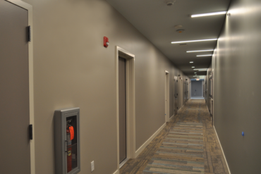 This hallway in Building B is now carpeted and nearing completion.