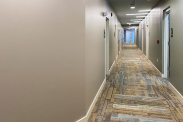 The carpet is installed in this hallway of Building A