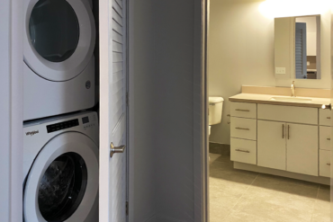 The stackable Whirlpool washer and dryer are installed in this Building A unit. Every apartment and townhome at VIDA includes them.