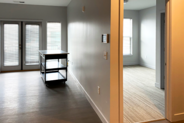 The flooring is installed and trim work is complete in this one-bedroom apartment with balcony in Building A.