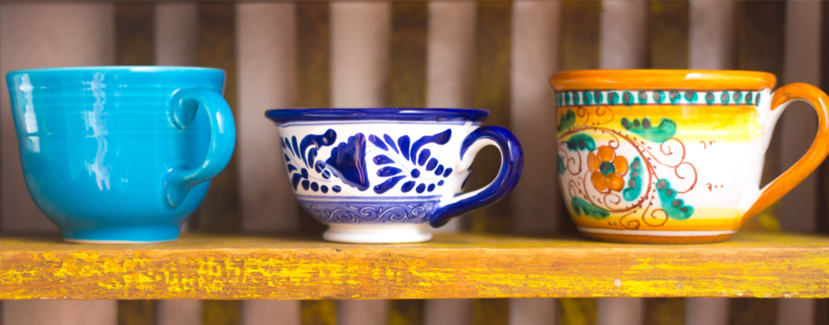 Mismatched mugs on a shelf. Image credit: iStock.
