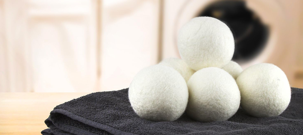 Several wool dryer balls sitting on a towel. Image credit: Amazon.