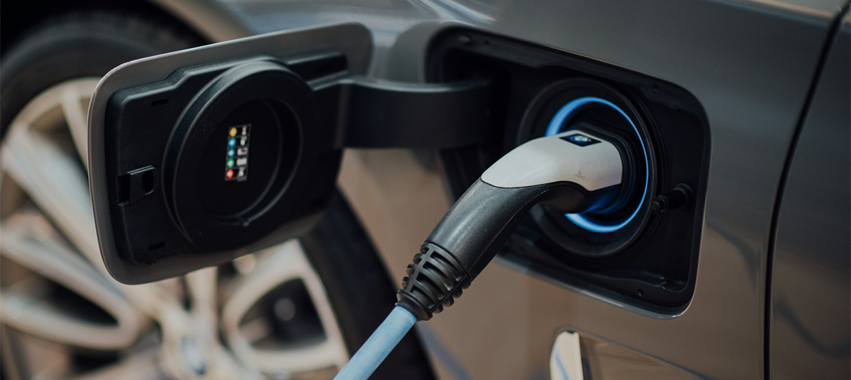 Charging plug in an electric vehicle. Image credit: Chuttersnap.