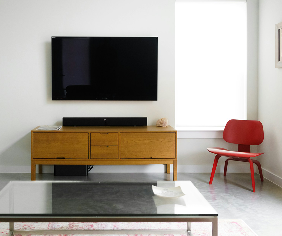 Single red chair in a neutral toned living room. Image credit: Thom Miklovic