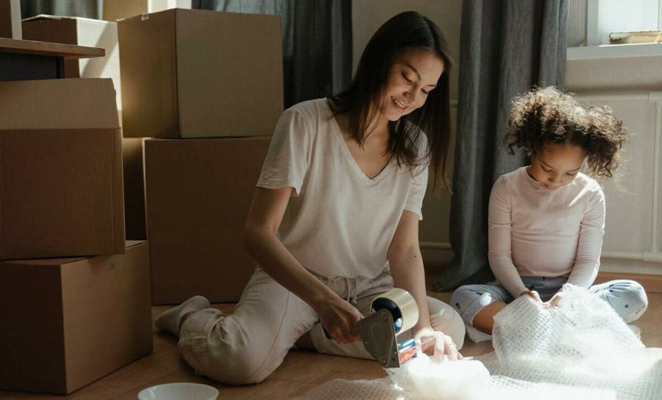 Mother and daughter packing to move