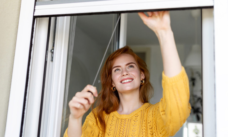 Woman opening a window